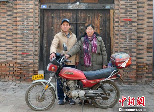 徐泽臣、赵淑芬夫妇展示家里1992年在全村购置的第一辆“一脚踹”（摩托车）。　张帆　摄